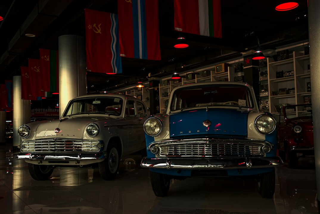 Interior of a classic car museum with vintage automobiles on display