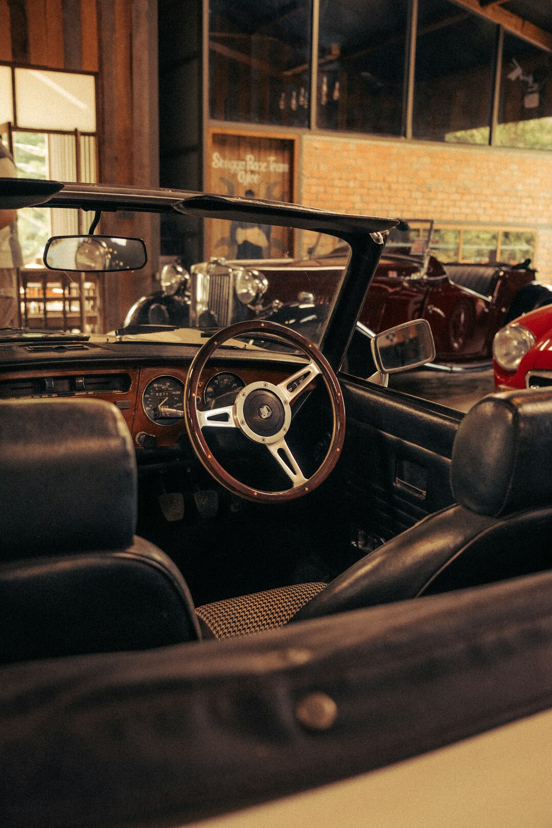 Vintage automobile interior with leather seats and wooden dashboard