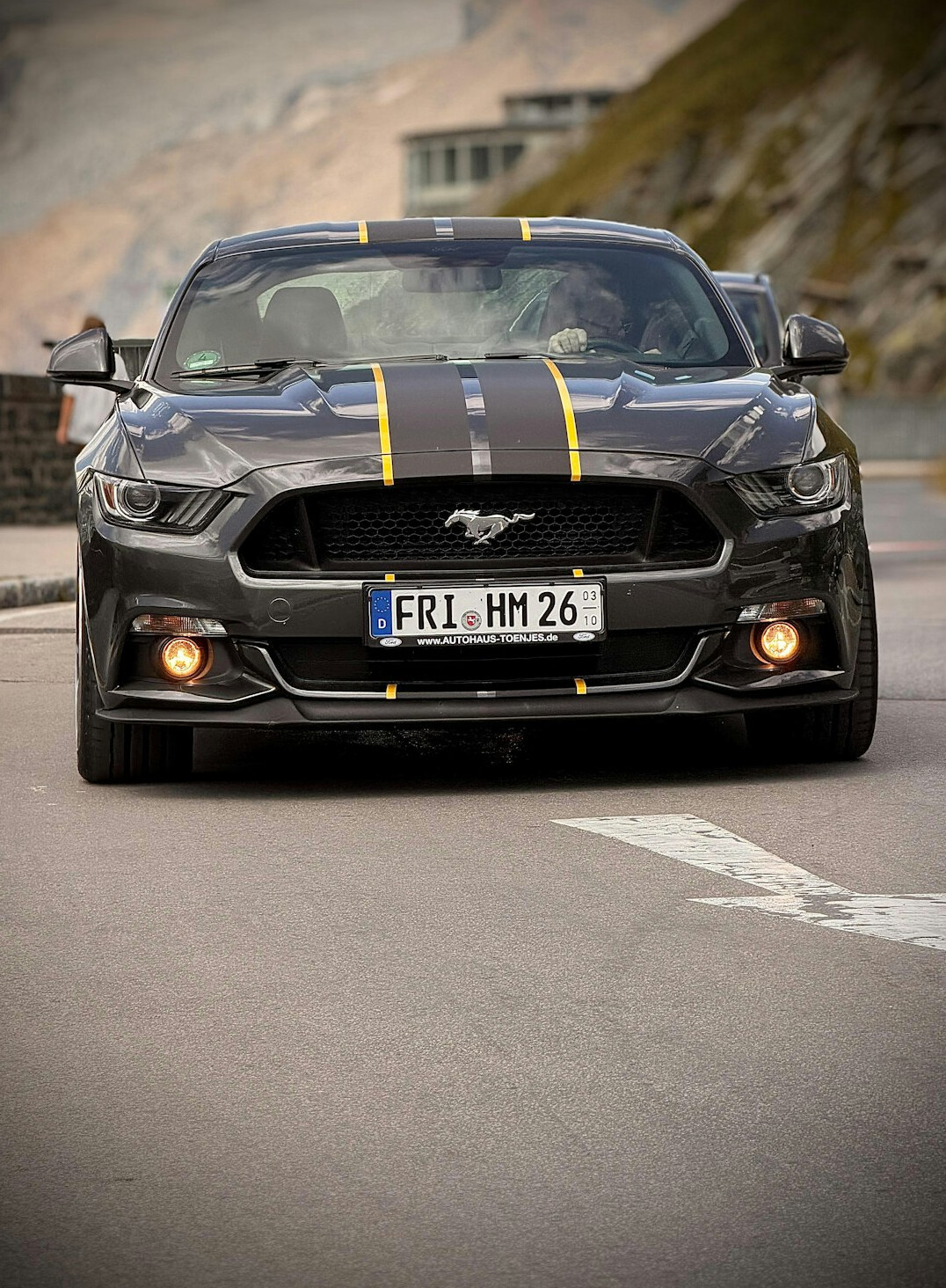 luxury sports car driving on mountain road