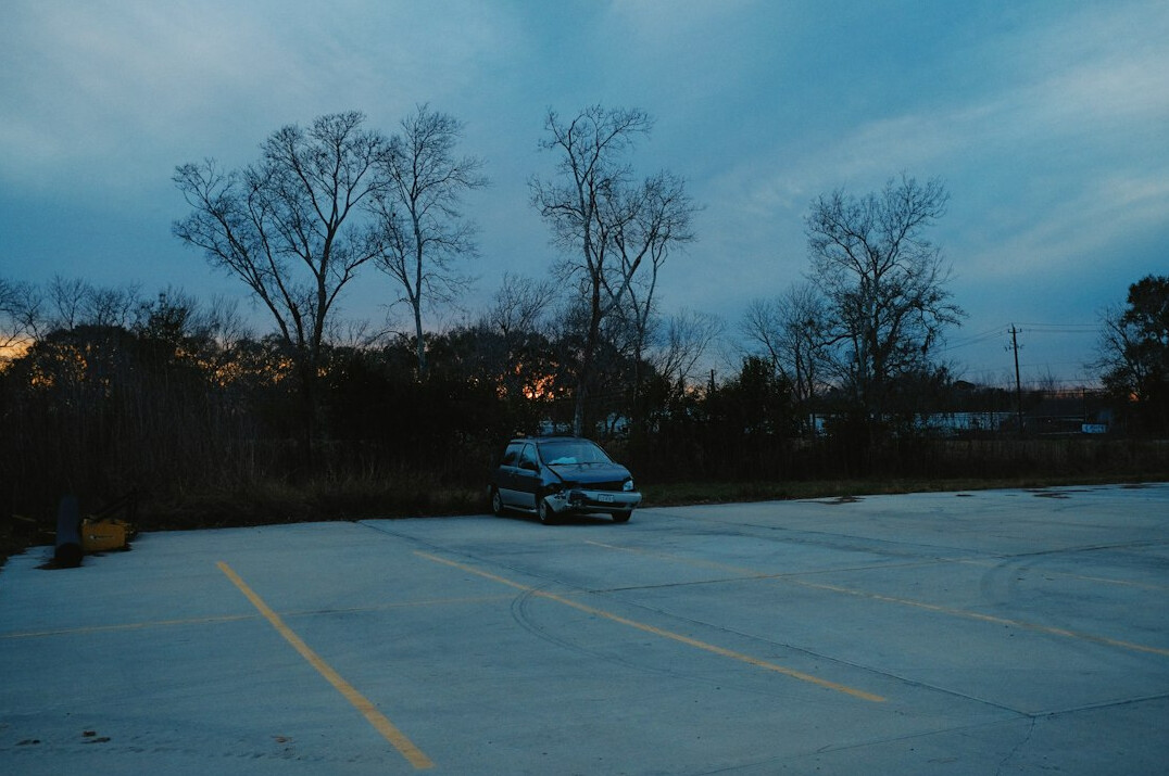 Modern hypercar parked on an empty road at dusk
